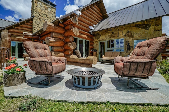 view of patio featuring an outdoor living space with a fire pit