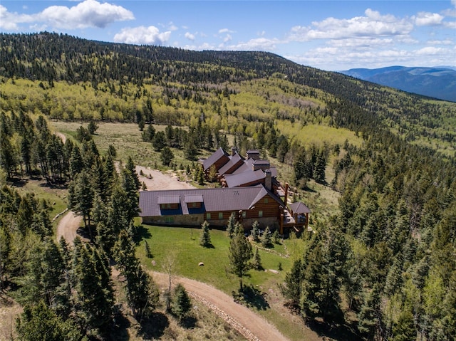 aerial view with a mountain view and a view of trees