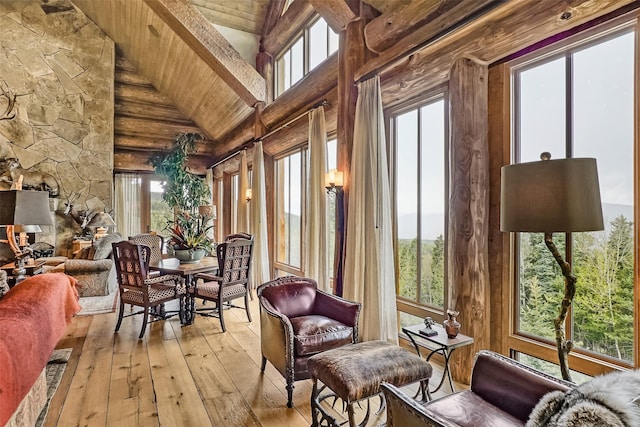 sunroom / solarium featuring hardwood / wood-style floors, beam ceiling, wooden ceiling, and plenty of natural light