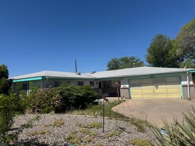 996 Camino Rizo, Santa Fe, NM 87505 - ranch-style house with a garage, brick siding, and driveway