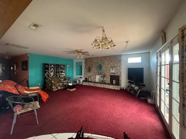 living room with a chandelier, carpet, and visible vents