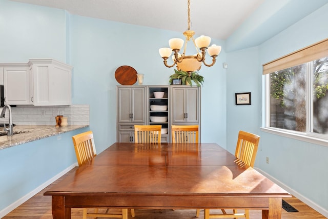 10335 Dunbar St NW, Albuquerque, NM 87114 - dining space featuring a notable chandelier, light wood finished floors, and visible vents