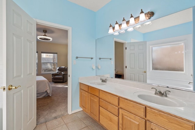 10335 Dunbar St NW, Albuquerque, NM 87114 - ensuite bathroom featuring tile patterned flooring, a sink, double vanity, and connected bathroom