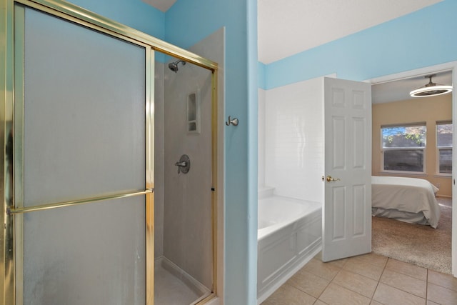 10335 Dunbar St NW, Albuquerque, NM 87114 - ensuite bathroom with a shower stall, a garden tub, tile patterned flooring, and ensuite bathroom