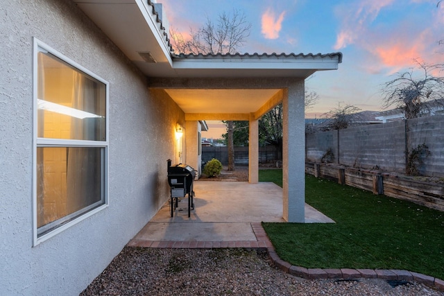 10335 Dunbar St NW, Albuquerque, NM 87114 - patio terrace at dusk featuring a yard, a fenced backyard, and a grill