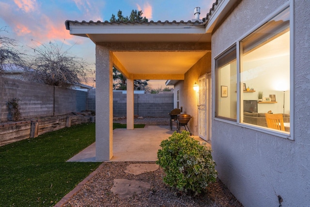 10335 Dunbar St NW, Albuquerque, NM 87114 - patio terrace at dusk featuring a fenced backyard and a yard