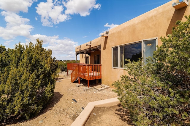 67A Blue Canyon Trl, Santa Fe, NM 87507 - view of property exterior featuring a deck and stucco siding