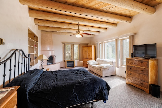 bedroom featuring beam ceiling, carpet flooring, wooden ceiling, and multiple windows