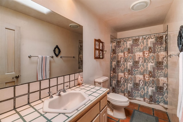 bathroom featuring toilet, vanity, and tile patterned floors
