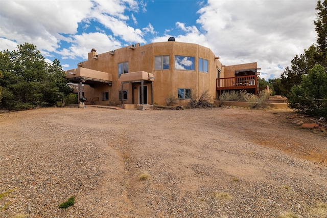 back of house with a balcony