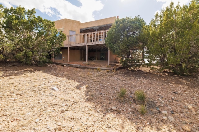 back of house with a wooden deck
