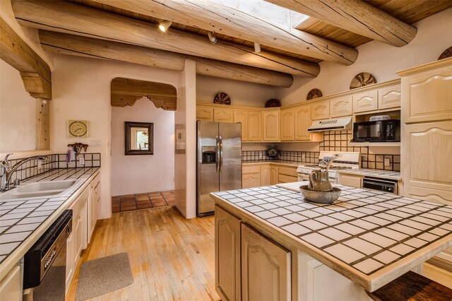 67A Blue Canyon Trl, Santa Fe, NM 87507 - kitchen with tile countertops, black appliances, under cabinet range hood, wooden ceiling, and a sink