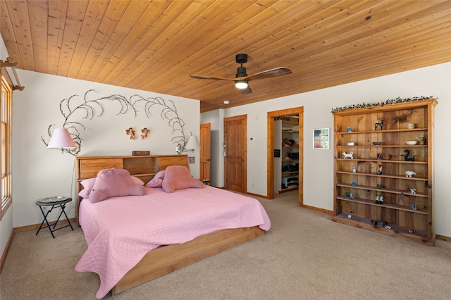 carpeted bedroom with wood ceiling, a ceiling fan, and baseboards