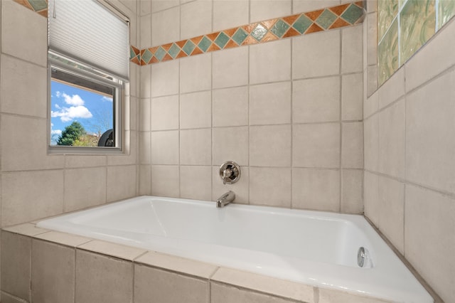 bathroom with tile walls and a garden tub