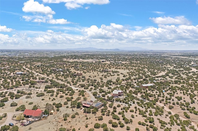 drone / aerial view featuring view of desert, a rural view, and a mountain view