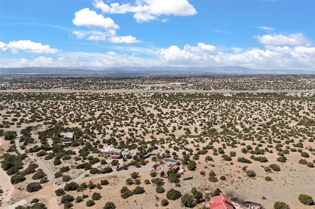 aerial view featuring a desert view and a mountain view