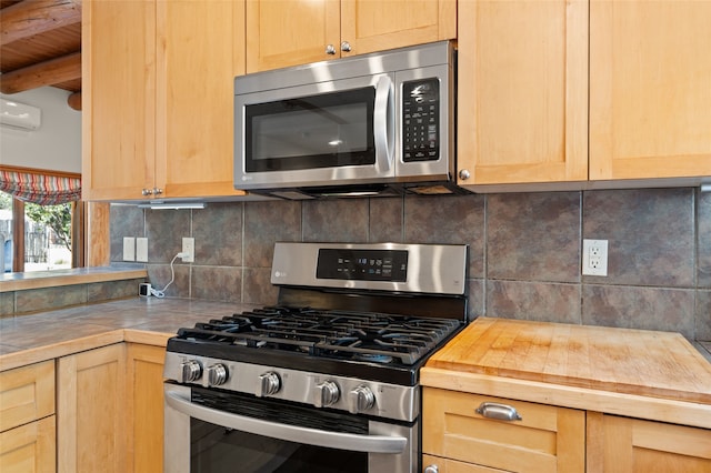 kitchen featuring wood counters, appliances with stainless steel finishes, tasteful backsplash, and light brown cabinetry