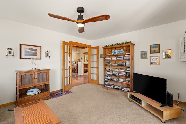 sitting room featuring french doors, baseboards, carpet, and ceiling fan