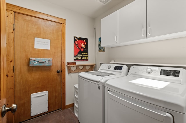 laundry area featuring visible vents, washer and clothes dryer, and cabinet space