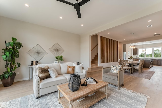 living area featuring stairway, ceiling fan, recessed lighting, and light wood-type flooring