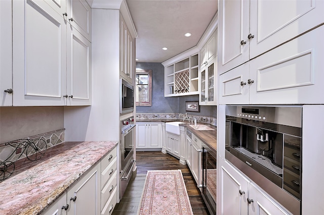 kitchen featuring wine cooler, oven, dark wood-style flooring, recessed lighting, and white cabinetry