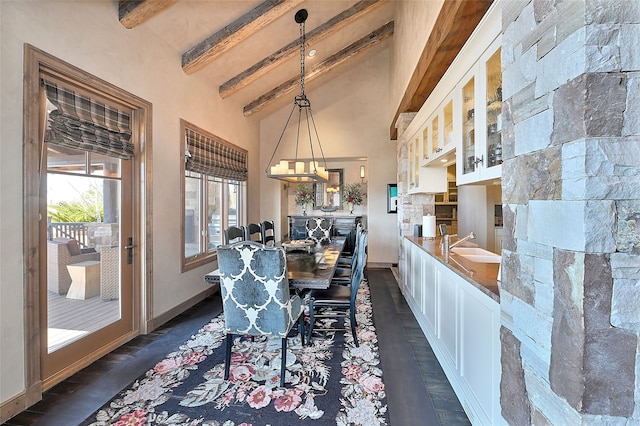 dining room with beamed ceiling, high vaulted ceiling, baseboards, and dark wood-style floors