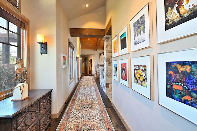 hall featuring baseboards, beam ceiling, high vaulted ceiling, and dark wood finished floors