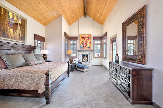 bedroom with carpet, a warm lit fireplace, wooden ceiling, beam ceiling, and high vaulted ceiling