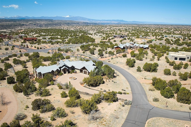 drone / aerial view featuring view of desert and a mountain view