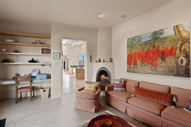 living room featuring finished concrete floors and a warm lit fireplace