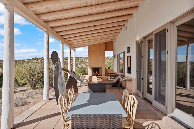view of patio featuring an outdoor living space with a fireplace