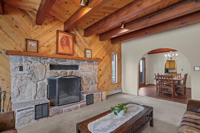 11 Sierra Lejana, Santa Fe, NM 87508 - living area with wood walls, arched walkways, beamed ceiling, a baseboard radiator, and carpet flooring