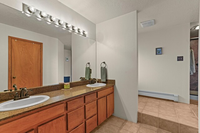 11 Sierra Lejana, Santa Fe, NM 87508 - full bath featuring tile patterned floors, baseboard heating, a sink, and double vanity