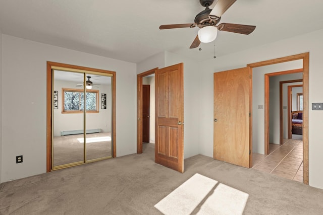 11 Sierra Lejana, Santa Fe, NM 87508 - unfurnished bedroom with baseboard heating, light carpet, a ceiling fan, and a closet