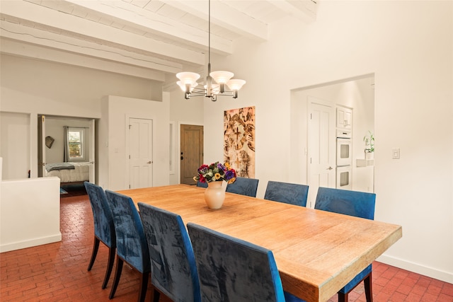 dining room with baseboards, beam ceiling, a chandelier, and brick floor