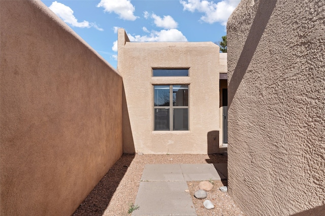 view of side of property with stucco siding
