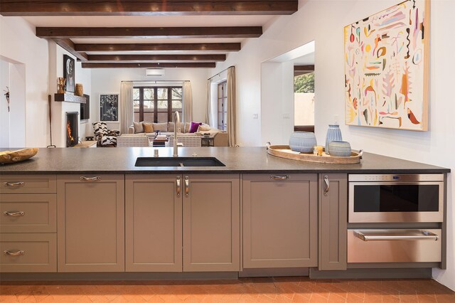 6 El Nido Ln, Santa Fe, NM 87506 - kitchen featuring a sink, a healthy amount of sunlight, a warming drawer, dark countertops, and open floor plan