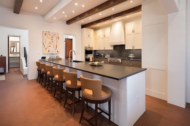 6 El Nido Ln, Santa Fe, NM 87506 - kitchen with beam ceiling, a sink, dark countertops, recessed lighting, and custom range hood