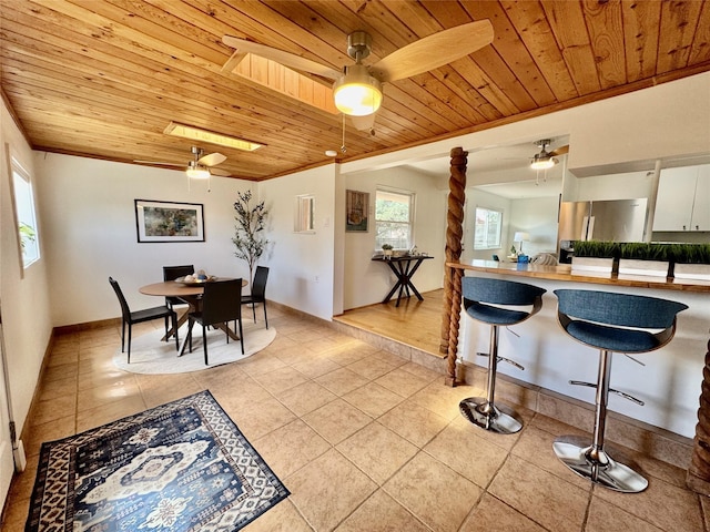 dining space featuring wood ceiling, ceiling fan, and light tile patterned flooring