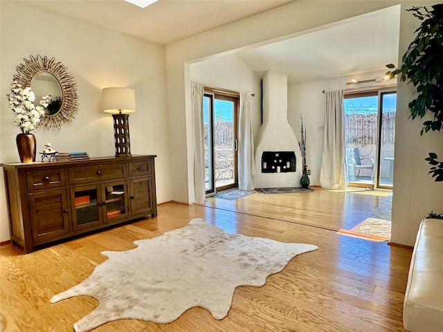 living area featuring baseboards and light wood-style floors