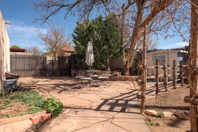 view of patio with fence and outdoor dining space