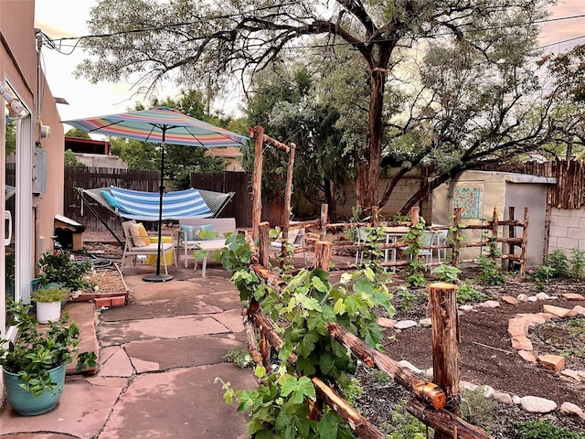 view of patio / terrace featuring a fenced backyard and a garden