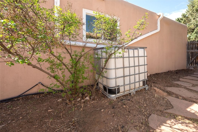 view of home's exterior featuring stucco siding and fence