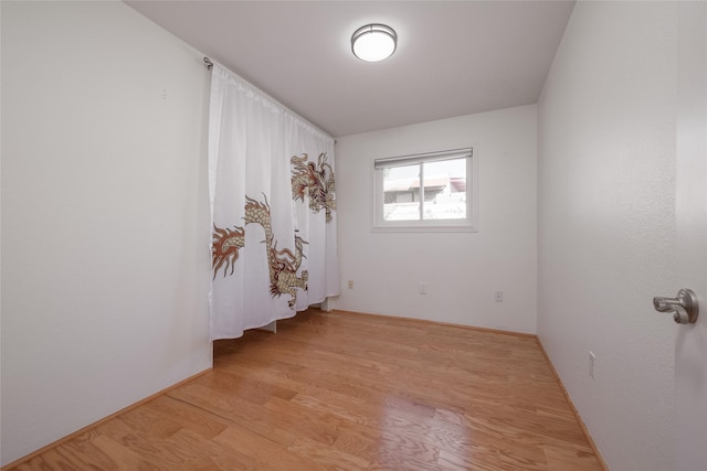 unfurnished room with light wood finished floors