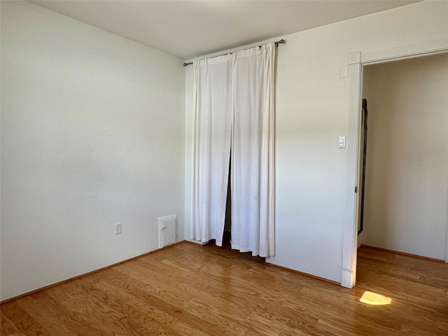 unfurnished room with light wood finished floors