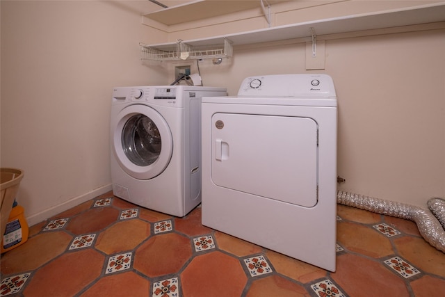 laundry room featuring washing machine and dryer, baseboards, and laundry area
