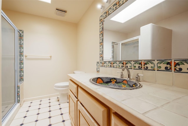 full bathroom featuring tile patterned floors, vanity, a shower stall, and toilet