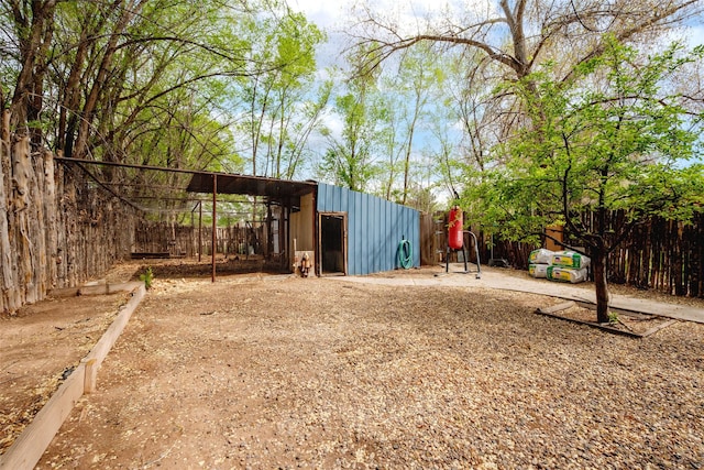 view of pole building featuring fence
