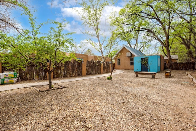 view of yard with fence and an outdoor structure
