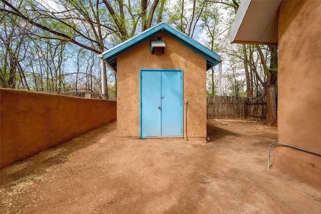view of shed with fence